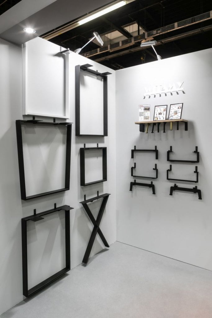 Stalowe nogi do stołów i biurek oraz nowe nóżki do mebli skrzyniowych w kolorze czarnym firmy Gamet zawieszone na ścianie prezentowane podczas tragów Warsaw Home & Contract 2021 - miesięcznik i portal informacyjny branży meblarskiej biznes.meble.pl