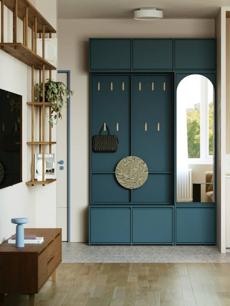 Kolekcja mebli modułowych Ragnar marki Górna Półka w kolorze Nocnej Żeglugi. Centralnym elementem aranżacji jest stylowy, granatowy zestaw szafek, pawlaczy i wieszaków, które łączą funkcjonalność z nowoczesnym designem.