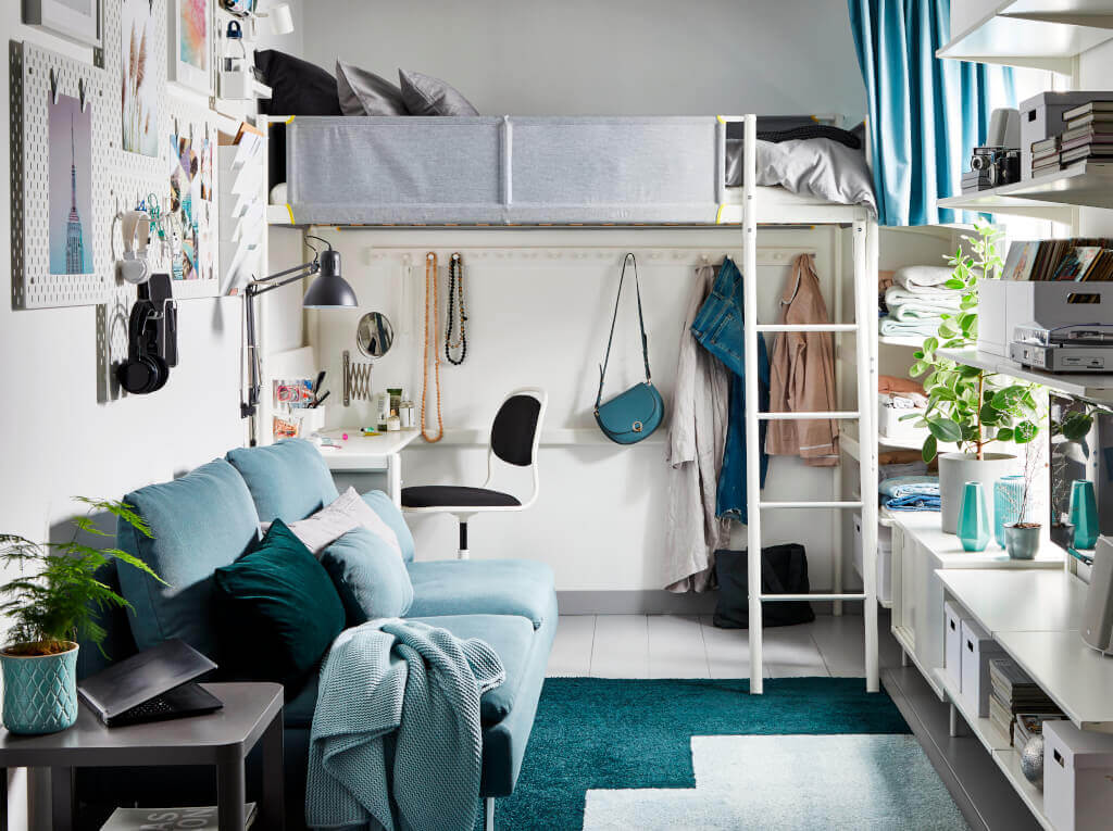 Rama łóżka na antresoli z blatem „Vitval”, tablica perforowana „Skådis”, ława ze schowkiem „Mackapär”, stolik na kółkach „Tingby”, dywan z długim włosiem „Kongstrup” – wszystko od IKEA.