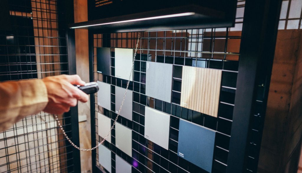 Oświetlone kwadratowe próbki dekorów na stojaku. Ekspozycja Impress Decor w ramach koncepcji „Imagine ... your World” podczas tygodnia designu w Mediolanie.