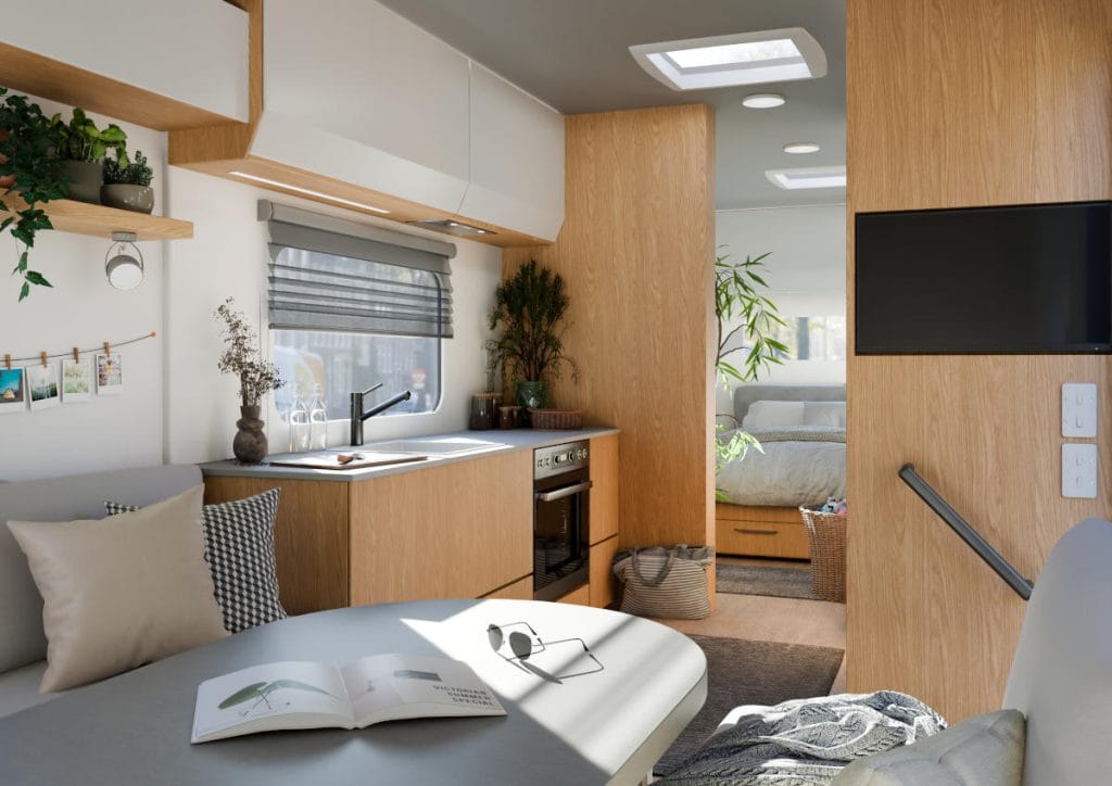 Przytulne wnętrze kampera z dębowym dekorem Rookwood Oak z kolekcji CARAVAN Interprint – kuchnia i strefa wypoczynku