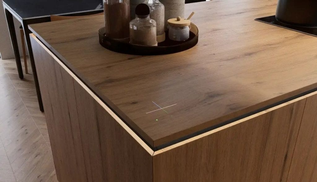 Drewniana wyspa kuchenna z ukrytym czujnikiem dotykowym – detale technologii typu inteligentny dom i kuchnia smart z niewidocznymi przyciskami sterującymi.