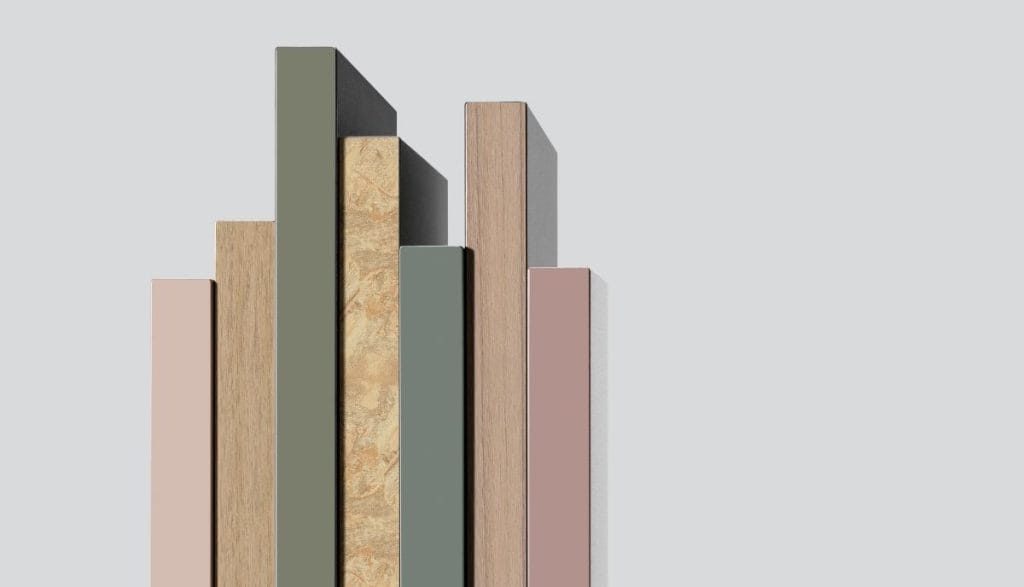 Zestawienie różnych dekorów frontów – od pasteli po struktury drewna i kamienia – wykończonych przez obrzeża meblowe RAUKANTEX, pokazujące szeroką gamę kolorystyczną.