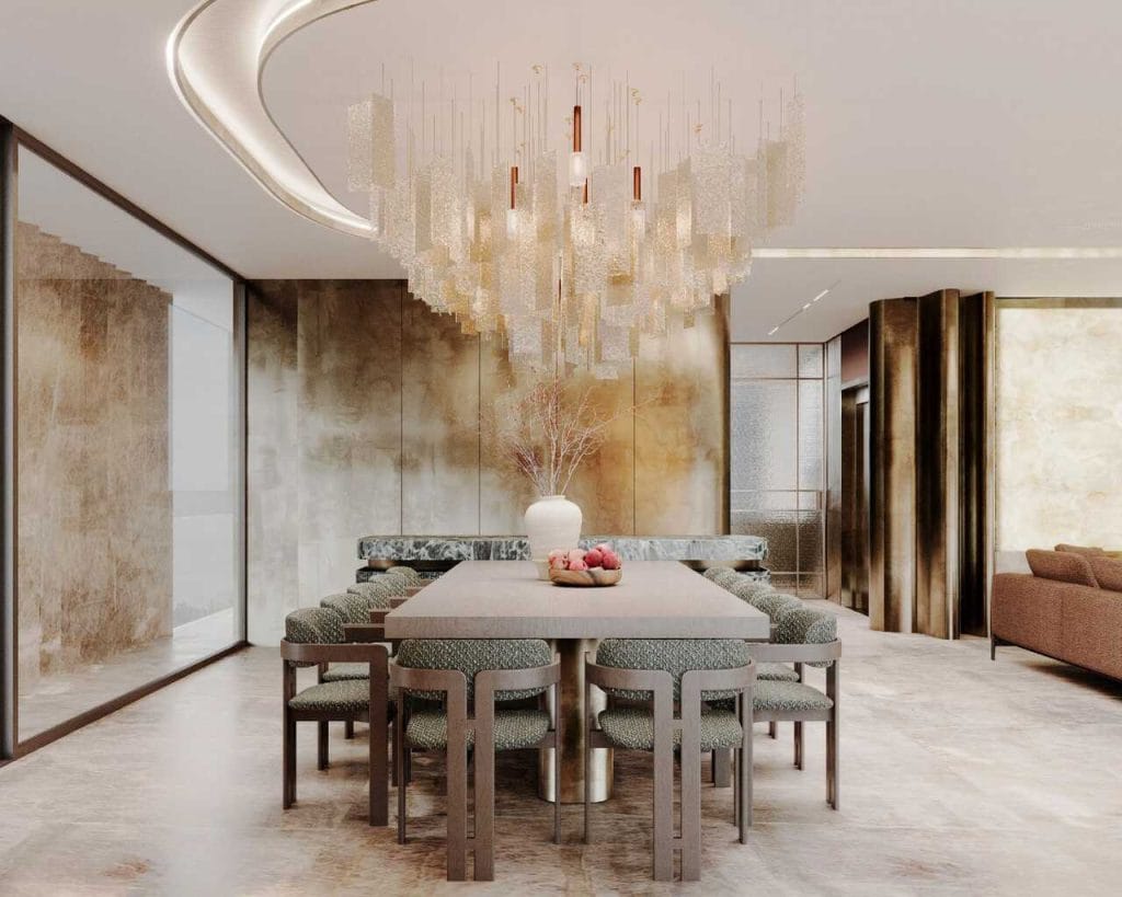 Strefa jadalni: Monumentalny stół z zielonego marmuru Verde Alpi pod świetlną instalacją, która przypomina deszcz zatrzymany w czasie.