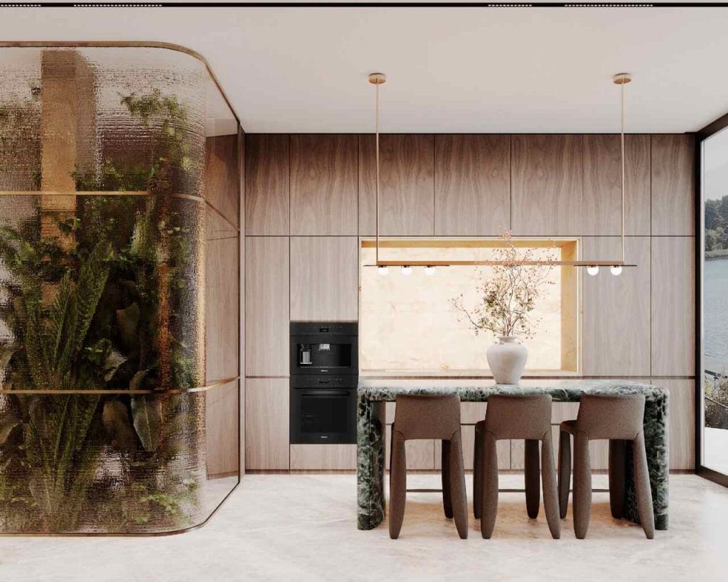 Kuchnia z widokiem: Minimalistyczna wyspa kuchenna wykonana z kamienia nawiązującego do barw jeziora, sąsiadująca z „zieloną ścianą” za szkłem katedralnym.