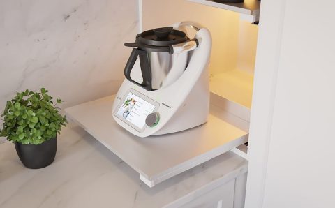 Detaliczny widok wewnętrznej wysuwanej półki REJS Puro w jasnym wykończeniu, z postawionym robotem kuchennym Vorwerk Thermomix i ziołami, na tle marmurowego blatu.