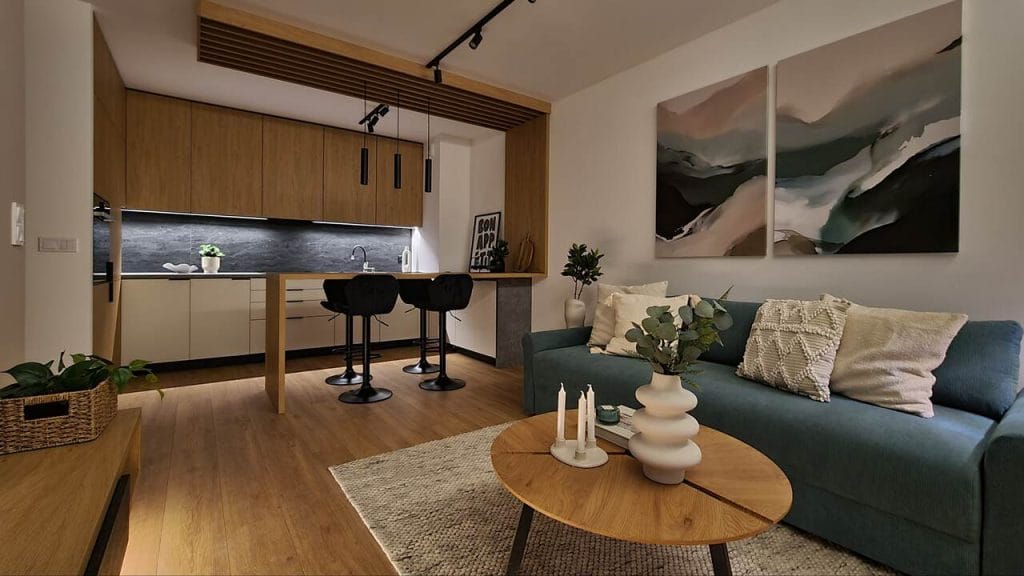 Około 50-metrowy apartament w nowej inwestycji  os. Lasówka – Kraków to jeden z kilku zrealizowanych przez Swałtek Design Studio w tej lokalizacji bliźniaczych, budżetowych lokali  wykończonych „pod klucz” i przeznaczonych na sprzedaż lub pod wynajem. Dekor jasnego dębu, w połączeniu z jasnym beżem, uzupełniają czarne detale i sprzęty. Projekt i realizacja: Swałtek Design Studio.
