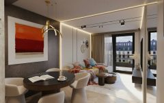 Apartament o pow. ok. 55 m2 w inwestycji Młyny Mogilska w Krakowie. Większość ścian przeznaczonego pod wynajem dla klienta premium lokalu wykończono z wykorzystaniem spieków wielkoformatowych i płyt meblowych pokrytych orzechowym fornirem lub lakierowanych w odcieniach jasnego beżu. Szlachetne faktury o stonowanych, choć kontrastujących barwach, dopełniono akcentami w intensywniejszych kolorach. Projekt i realizacja: Swałtek Design Studio.