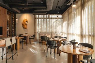 Studio Rysik stworzyło dla restauracji Bez Gwiazdek w sercu Powiśla przestrzeń pełną harmonii i spokoju. Naturalny len w oknach i szklanych przegrodach delikatnie filtruje światło, odcinając gości od zgiełku ulicy Wiślanej i wprowadzając ich w nastrojową strefę barw ziemi. Fot. Anna Gudaniec.