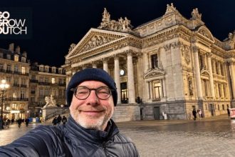 Jack Kleppe (Go Grow Dutch) uśmiecha się na selfie na tle brukselskiej Giełdy w nocy. Fotografia powiązana z tematem: lead generation w Beneluksie.